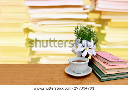 tea and book on blur stacking book with color filter background