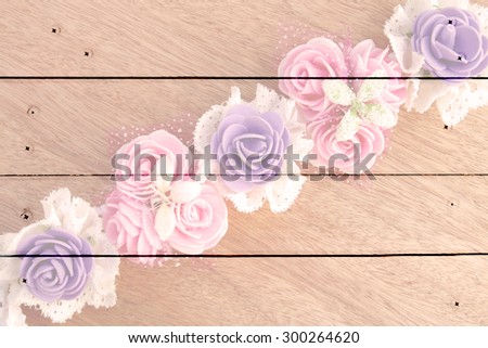 artificial flower on wooden wall and nails background