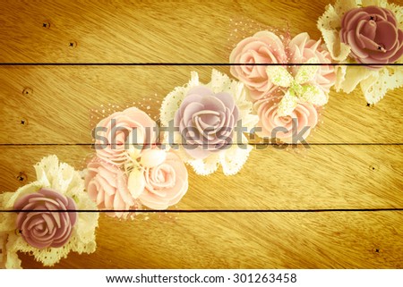 artificial flower on wooden wall and nails background