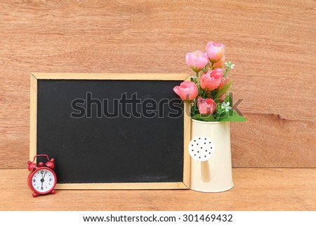 blackboard and vase on wooden background
