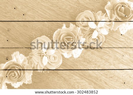 artificial flower on wooden wall and nails background ,vintage tone