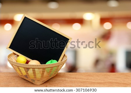 blackboard in toy basket on blur light in restaurant background