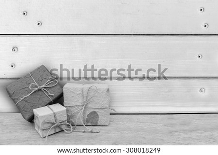 gift box with wooden wall and nails background ,black and white tone