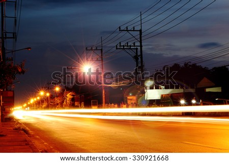 blur image of light and flare light on road in night time