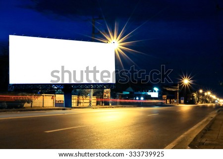 outdoor billboard and light on road in night time