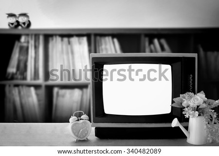 old television on blur book shelf background
