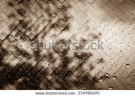 blur drop on mirror with dark tree background screen on dirty brick floor