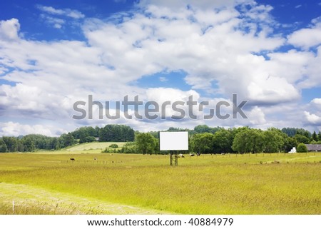 rural landscape with cows and blank billboard