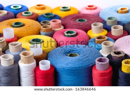 landscape close up of spools of thread of different size, texture and colour