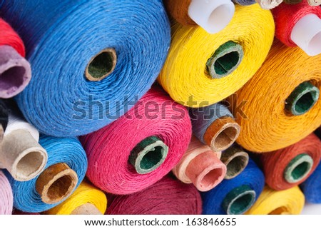 close up of spools of thread of different size, texture and colour