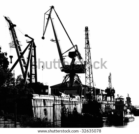 Silhouettes of Portal Cranes in a Harbor