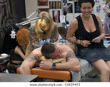 stock photo : SAINT PETERSBURG - JUNE 20: Tattoo artist at work at St.