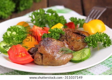 Warm salad with chicken liver, sweet peppers, cherry tomatoes and salad mix