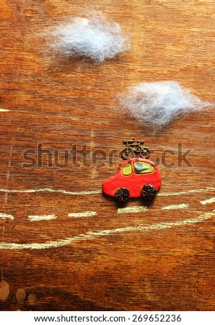 decorative landscape. Little car drives on the road, bicycle is on the car.