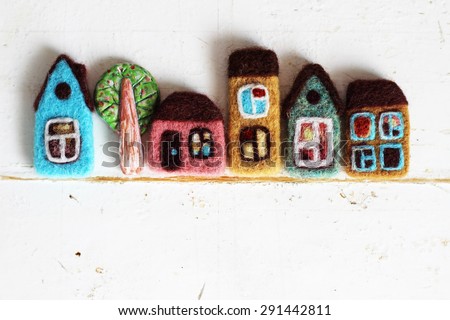 toy city, little houses and tree on light vintage wood background.