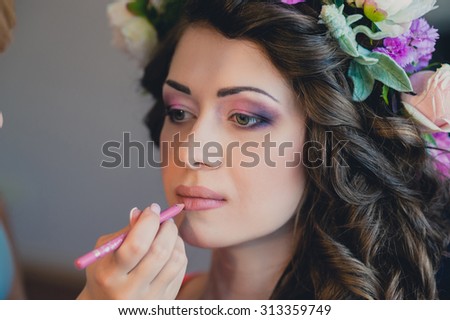 The visagist is applying wedding  makeup. Beautiful Bride Portrait wedding makeup, wedding hairstyle, Wedding dress