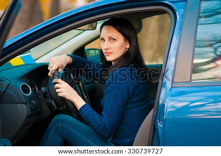Young female driving happy about her new car or drivers license.