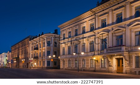 Street view at night in Helsinki, Finland. Historic buildings across the street from the Market Square.