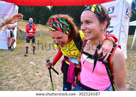 rausor, romania - august 1, 2015: two women crossing the finish line at the trail running race \