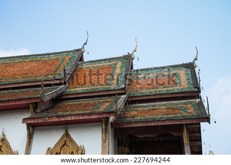 Beautiful roof tiles of temple in Chiang mai, Thailand blue sky - public