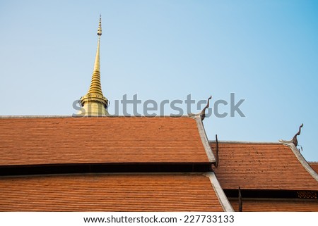 Beautiful roof tiles of temple in Chiang mai, Thailand blue sky
