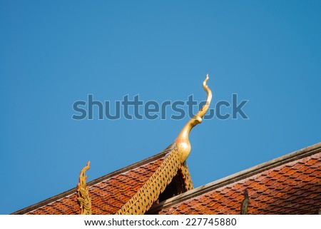 Beautiful roof tiles of temple in Chiang mai, Thailand blue sky - public place
