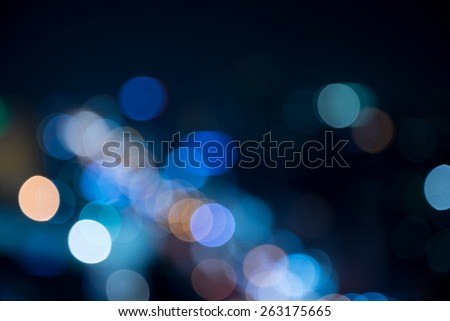 Defocused urban abstract texture -blurred background with bokeh of city lights from car on street at night
