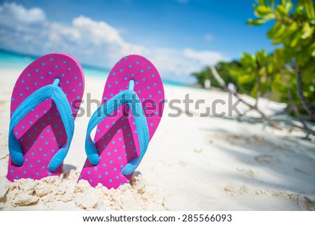 Pink beach flip flops and on tropical sand beach Thailand