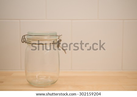 Empty glass jar in warm light - selective focus