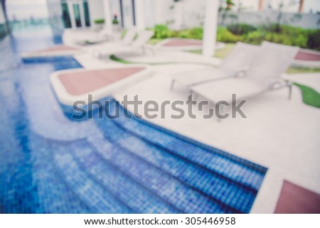 Abstract defocused roof top deck swimming pool on top of building blur background - Color tone effect