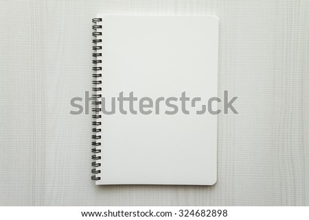 Blank empty notepad on white wood table