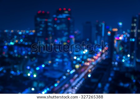 Defocused urban abstract texture -blurred background with bokeh of city lights from car on street at night
