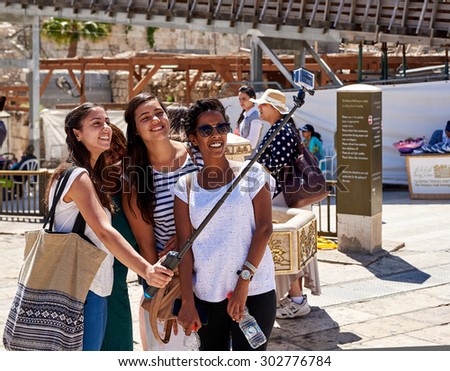 JERUSALEM, ISRAEL - JUNE 4, 2015: Smiling girls are taking selfie shot near the Western Wall and Temple Mount in Jerusalem. The Western Wall and Temple Mount are the most famous landmarks in Israel.