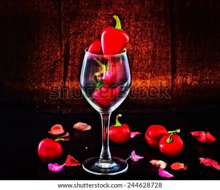 Red hot chili peppers, a symbol of passion in the shape of heart in glass