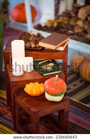 pumpkins with fall leaves and books