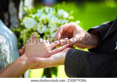 Marry me. Groom put a ring on finger of his lovely wife. Wedding couple together.