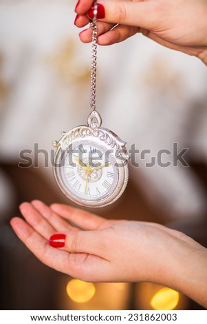 antique pocket watch in the women\'s hands