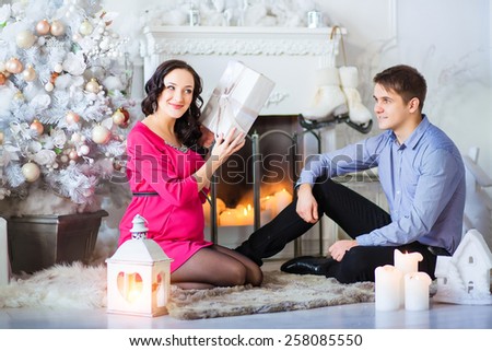 Offering a present to his pregnant wife