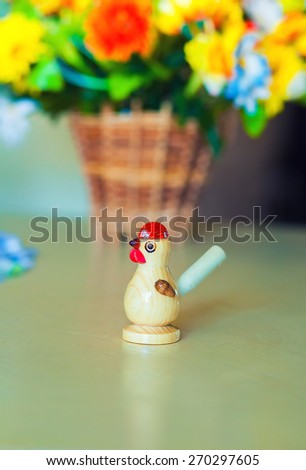 wooden whistle in the bird shape on table