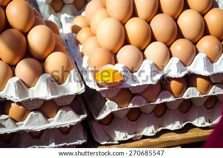 A set of brown eggs in a plastic tray