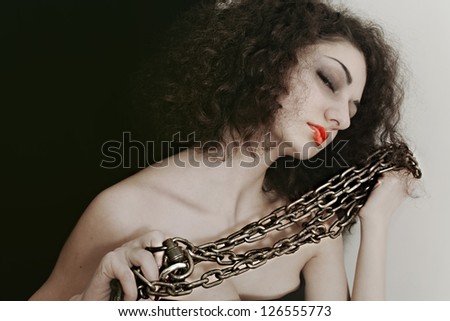 Portrait of a young woman with a metal chain closeup