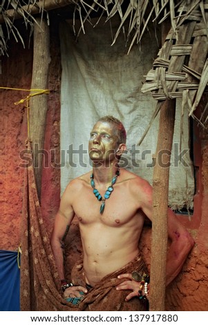 Portrait of adult man with theatrical ethnic makeup