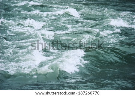 River water with turbulent flow close up
