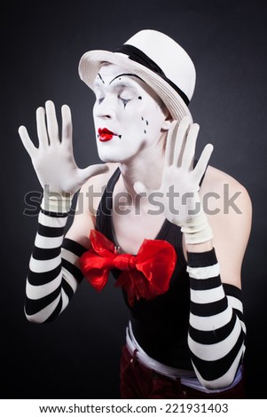 Portrait of theatrical mime on a black background