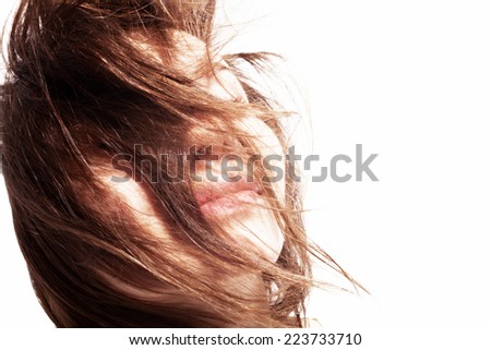 Portrait of a beautiful young woman with hair in the wind