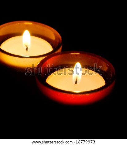 burning decorative candles photographed in the dark