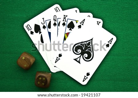 Playing cards and dice on a green background
