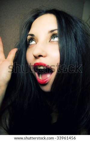 Portrait of the surprised beautiful woman with an open mouth