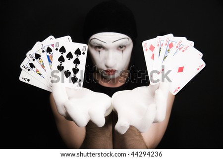 Portrait of mime with  royal flush on a black background