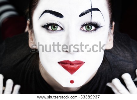 stock photo : A face of beautiful woman mime with green eyes close up